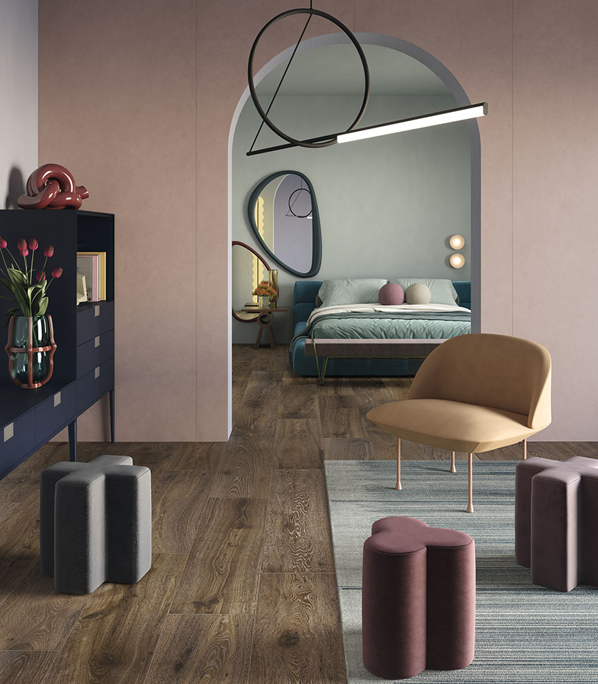 Modern bedroom with wood-effect flooring, soft pink walls and rounded furniture.
