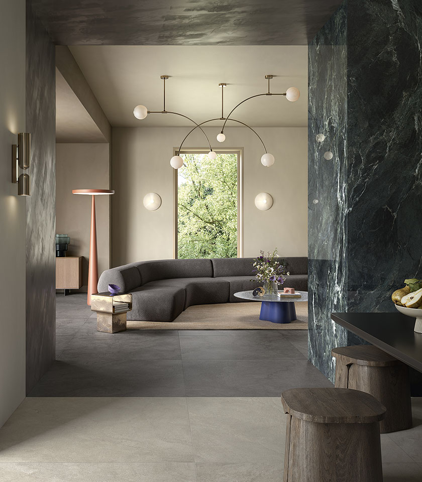 Pulse Clay and Shadow define a sophisticated, tactile living space, where stone-effect ceramic surfaces interact with the decorative intensity of Noblesse Verde Alpi.