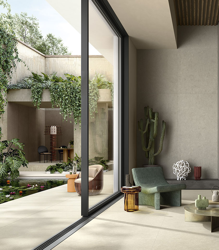 Contemporary indoor-outdoor space with flooring from the Intense collection in Clair stone effect, wall covering in the Perle shade and elements from the Pigmenti collection in the Pumice shade.