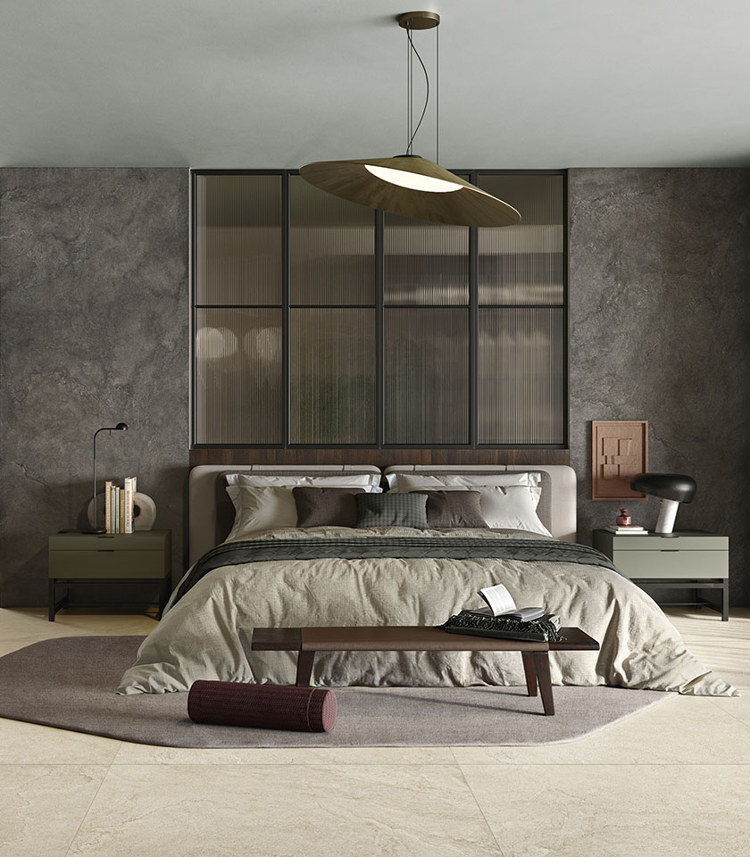 Contemporary bedroom with beige stone-effect flooring, dark textured walls and furnishings in neutral tones.