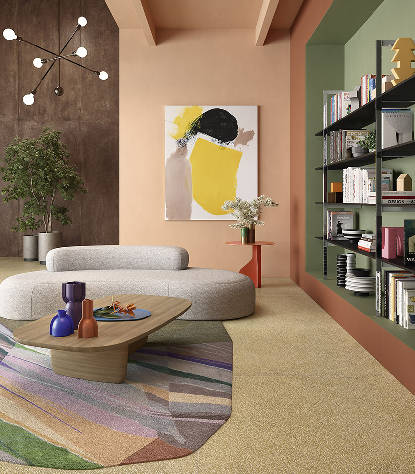 Contemporary living room with beige flooring, concrete-effect wall, sculptural sofa and built-in shelving against a green backdrop.