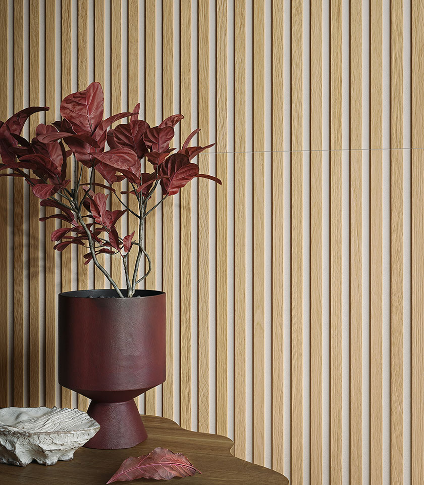 Detail of a three-dimensional light wood-effect wall covering with a burgundy vase and decorative botanical arrangement.